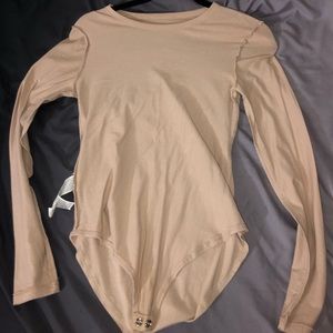 Tan, long sleeve bodysuit.